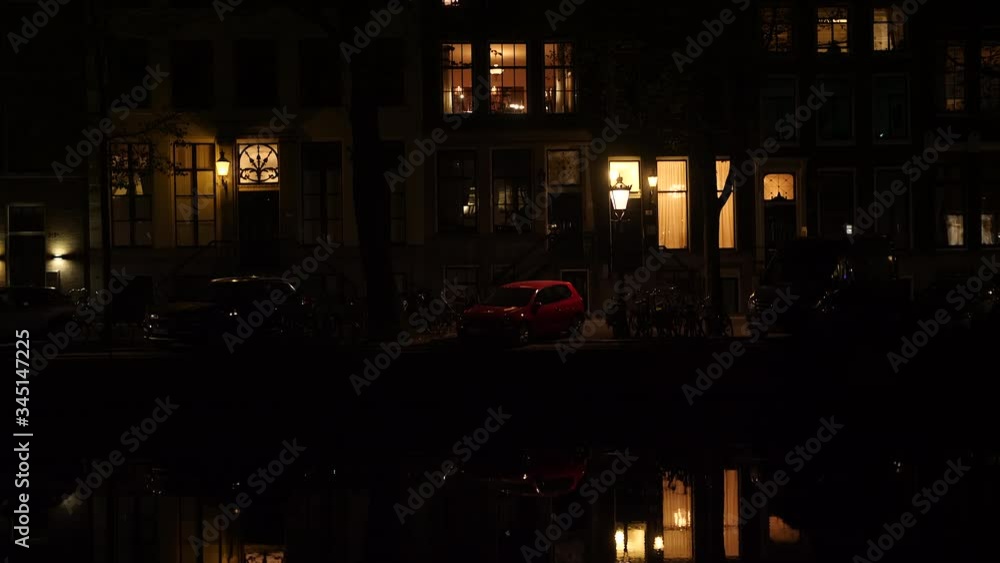 Historic houses at night and their reflection in the water. Amsterdam, the Netherlands. Tilt up shot. Historic houses at night and their reflection in the water. Amsterdam, the Netherlands. Tilt up shot.