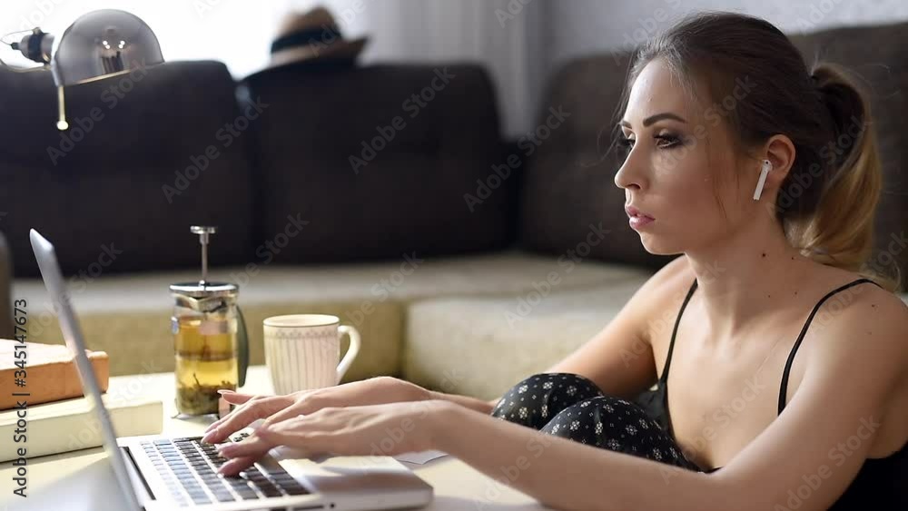 Education and study at home. A young woman using a laptop for studying, watching online lectures, workshops and master classes. Self-isolation at home. Education and study at home. A young woman using a laptop for studying, watching online lectures, workshops and master classes. Self-isolation at home.
