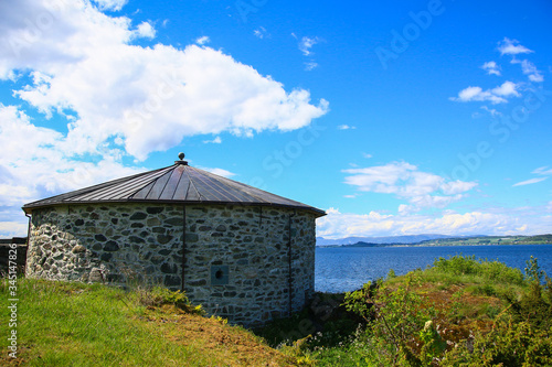 fisherman's house and fjord, Norway with blue sky and clouds photo