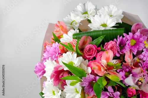 Colorful bouquet of mixed flowers on a gray background. Close-up.