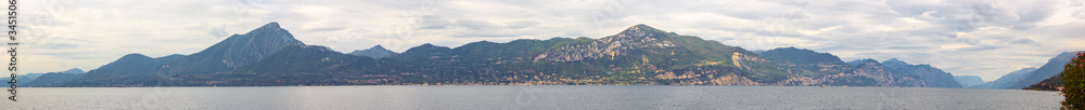 Nature,  mountains in the clouds and settlements around Lake Garda near the Sirmione town in Lombardy, northern Italy
