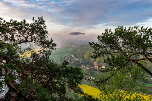 looking down to the village of Rathen in saxon switzerland in Germany while the sun is rising