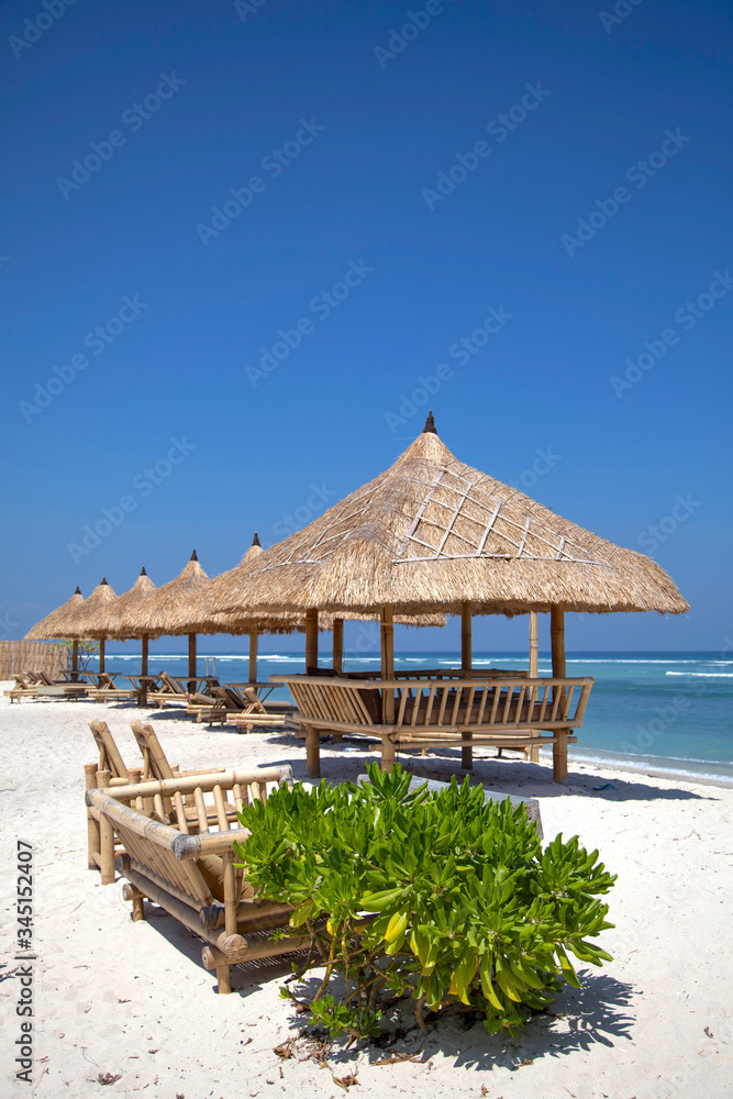 exotic beach umbrella hut on a tropical beach, gili trawangan island, Bali, Indonesia.