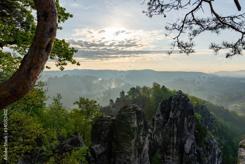 a beautiful view down in the tales from a viewpoint on the top of the Bastei in saxon switzerland, Germany