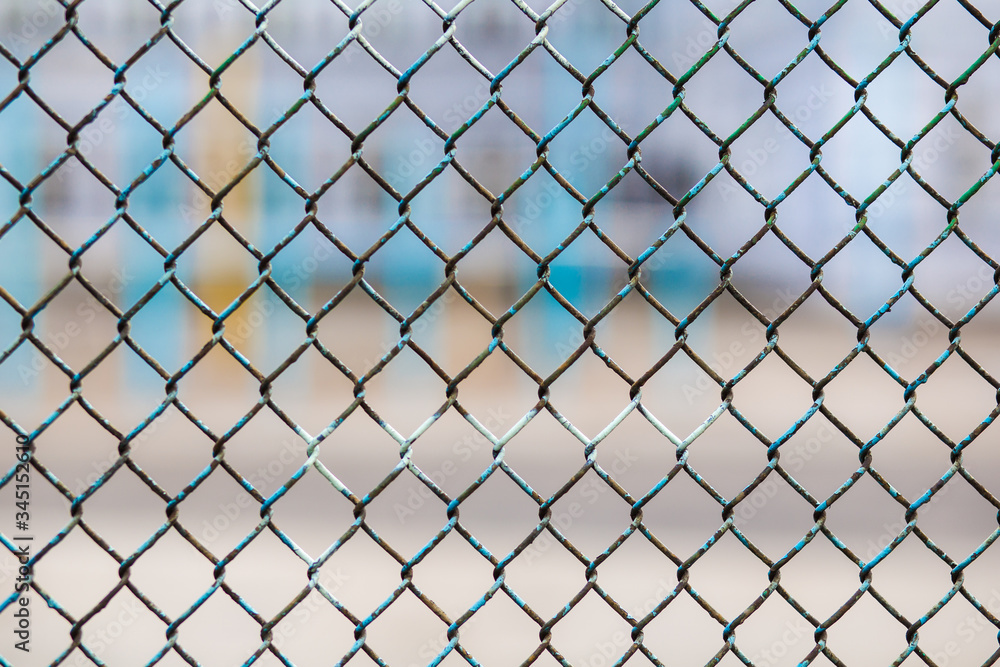 metal fence with buildings on the background metal fence with buildings on the background