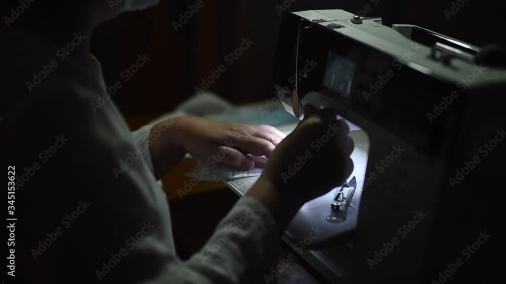 Sewing medical masks during the epidemic of the coronavirus Covid-19 pandemic. An elderly woman sews masks at home to protect against the spread of infection. Quarantine and self-isolation Sewing medical masks during the epidemic of the coronavirus Covid-19 pandemic. An elderly woman sews masks at home to protect against the spread of infection. Quarantine and self-isolation