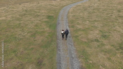 DRONE FOOTAGE - The Val d’Astau, southwest of Bagneres de Luchon in the French Pyrenees. Romantic couple holding hands walking in mountain. photo