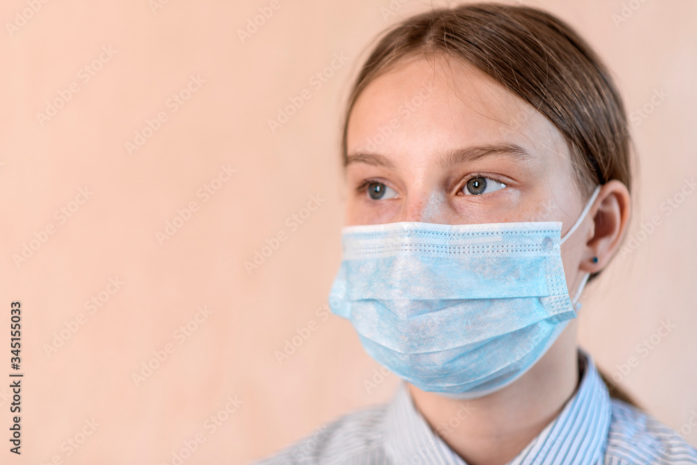 Teenager girl 14-15 years old, in protective mask, free space for copy text, anti-coronavirus COVID-19 pandemic infectious disease outbreak protection, healthcare concept Teenager girl 14-15 years old, in protective mask, free space for copy text, anti-coronavirus COVID-19 pandemic infectious disease outbreak protection, healthcare concept