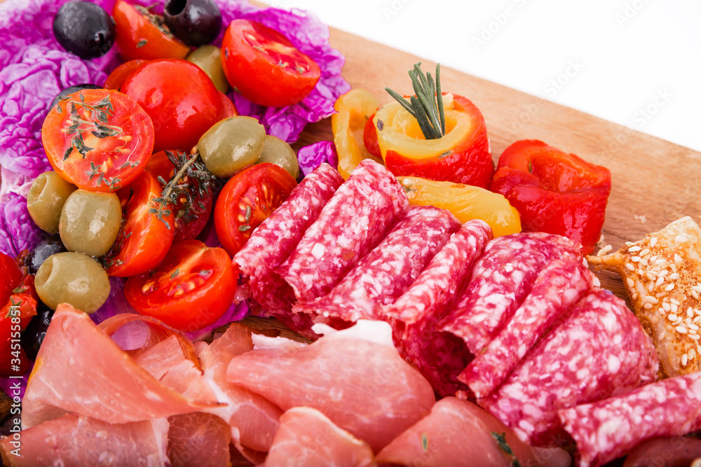 Assorted meat on a wooden board on a white background. Horizontal photo