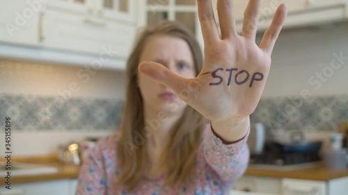 Young woman showing stop sign on the hand. Movement against sexual harassment.