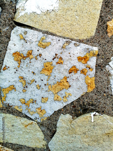 Stone wall with gold spots.