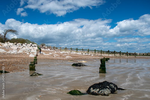 Beautiful view at low tide of Climping Beach on the south coast of England, the old wooden sea defences sinking into the sand. photo