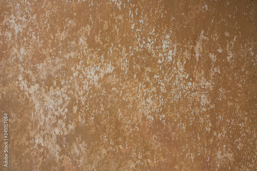 Orange Plastered Walls With Damages. A Time Shattered Plaster. Layers Of Building Materials, Plaster, Cement, Whitewash and Bricks. Chips, Cracks, Scrapes.