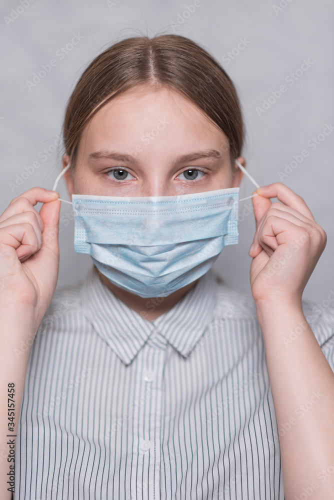 Girl teenager removes puts on protective mask, hands ending quarantine and changing mask, anti-coronavirus COVID-19 pandemic infectious disease outbreak protection, healthcare concept Girl teenager removes puts on protective mask, hands ending quarantine and changing mask, anti-coronavirus COVID-19 pandemic infectious disease outbreak protection, healthcare concept