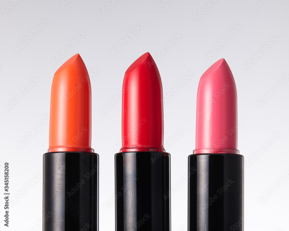 Close-up of the head of three red tone lipsticks. Close-up of the head of three red tone lipsticks.
