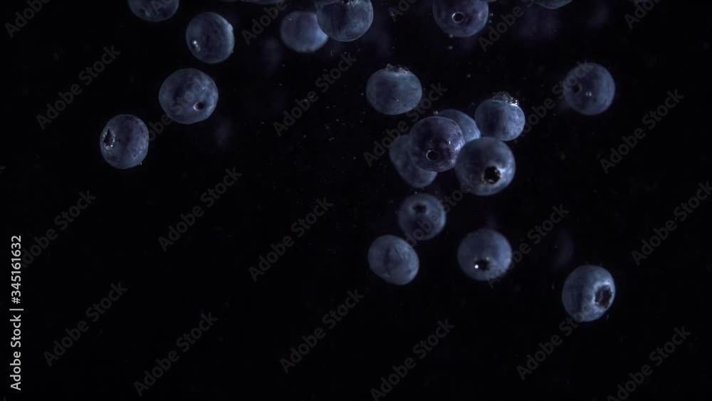 blueberries into the water on a black background
blueberries into the water on a black background