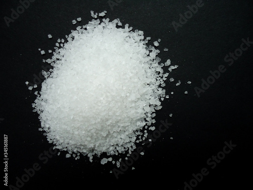 natural sea salt grains on dark background
