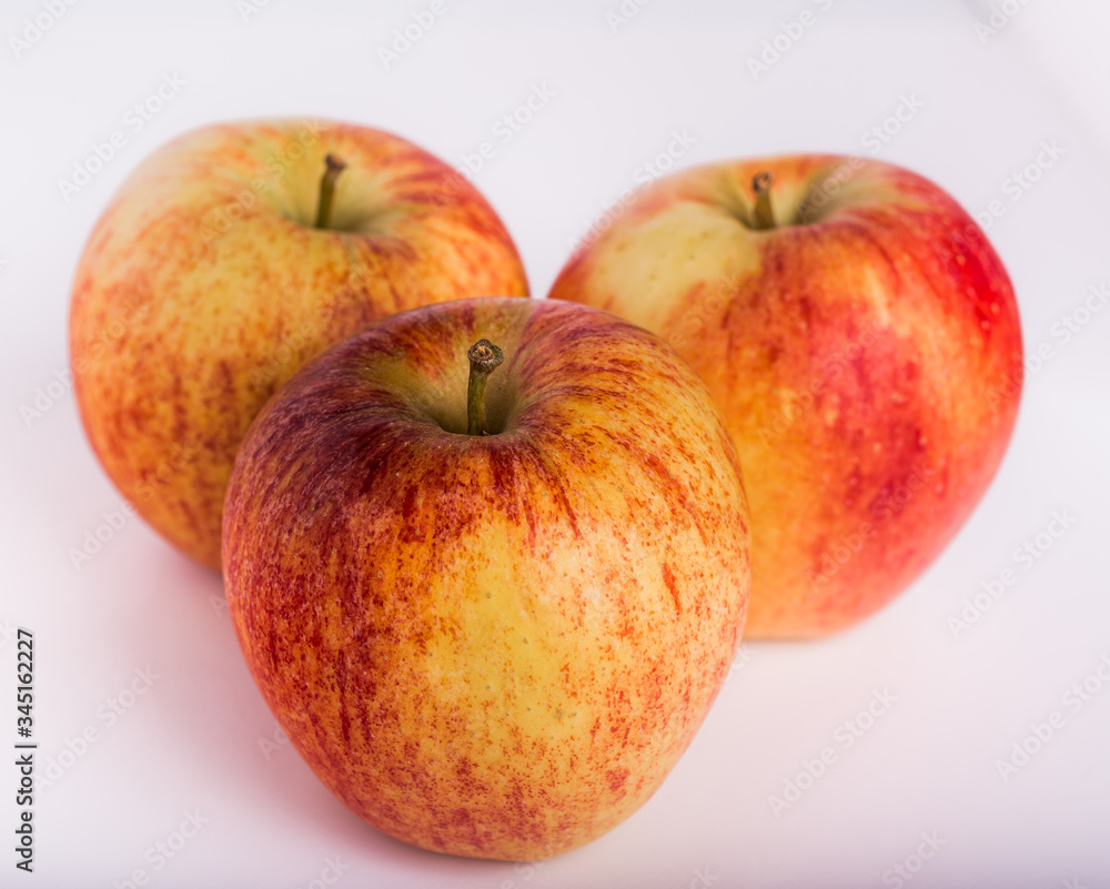 Three delicious red and yellow apples on white background. Horizontal format.
Three delicious red and yellow apples on white background. Horizontal format.