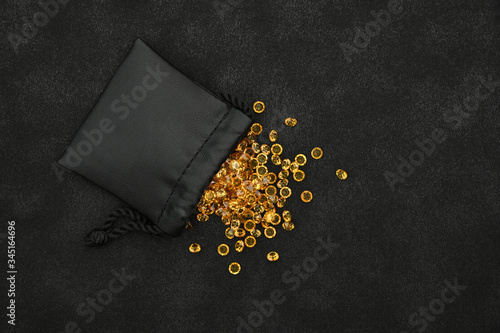 Heap of golden rhinestone crystals in bag
