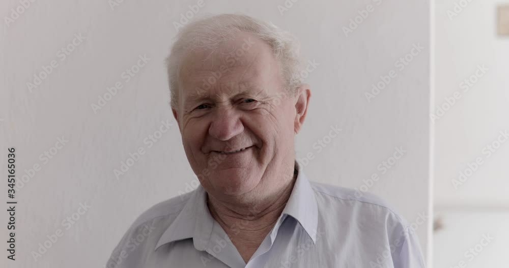 Portrait of handsome senior man laughing into camera on background Portrait of handsome senior man laughing into camera on background