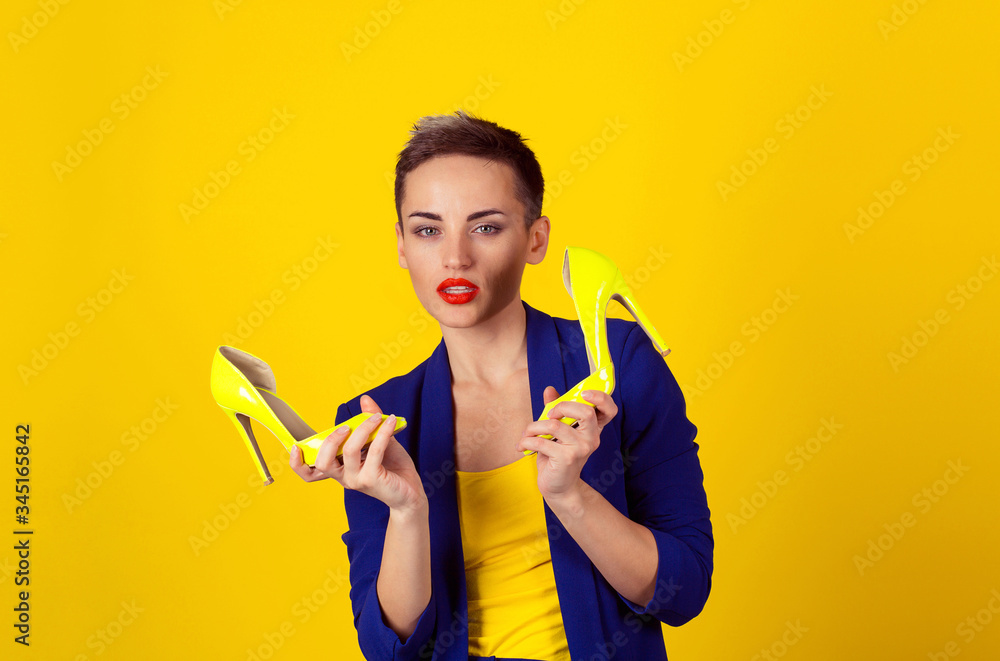 Portrait of a young beautiful woman holding a pair of shoes Portrait of a young beautiful woman holding a pair of shoes