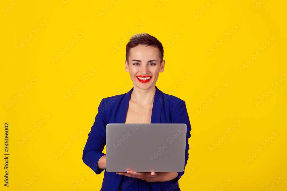 woman working on computer laptop looking at camera woman working on computer laptop looking at camera