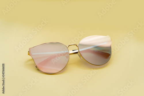 sunglasses with mirrored glasses on a yellow 