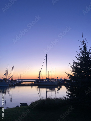 Harbor at sunset with silhouettes vertical