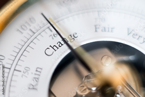 needle of a barometer pointing at the word change. close up of the word