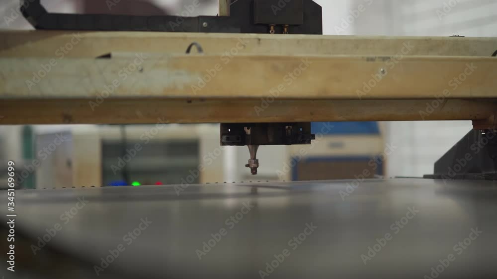 Industrial laser cutter with sparks. Clip. The programmed robot head cuts with the aid of a sheet of metal temperature. Industrial laser cutter with sparks. Clip. The programmed robot head cuts with the aid of a sheet of metal temperature.