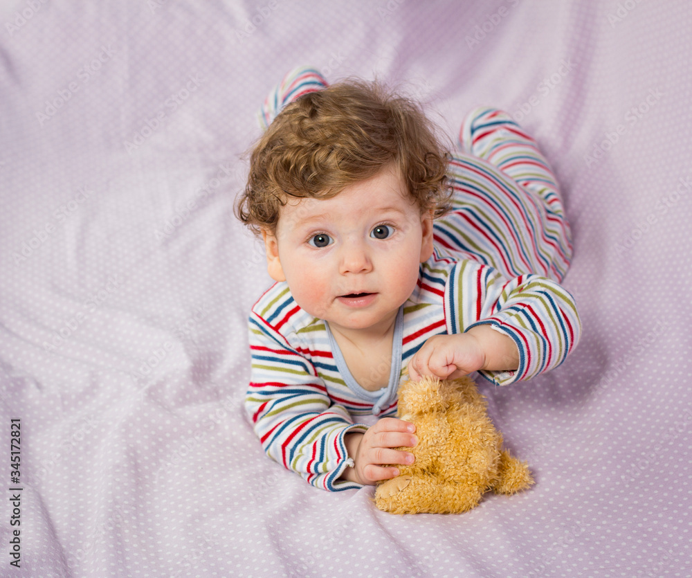 Little smiling boy on the bed. Child at home. Little smiling boy on the bed. Child at home.
