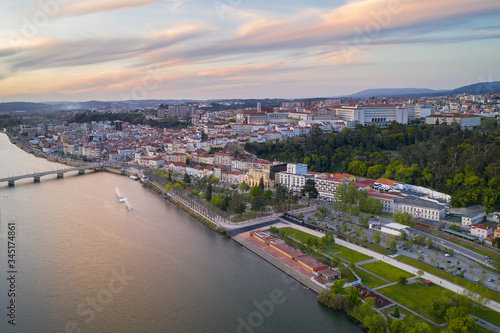 Coimbra drone aerial city view at sunset with Mondego river and beautiful historic buildings, in Portugal