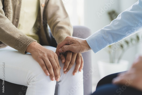 mental health treatment concept. Stressed asian patient talking with personal psychologist in therapist session have a and doctor touching her hand feel empathy.