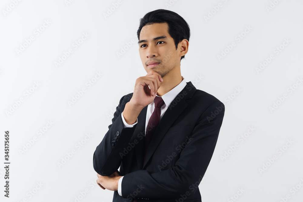 happy young asian businessman smiling and thinking in formal suit isolated on white background. happy young asian businessman smiling and thinking in formal suit isolated on white background.