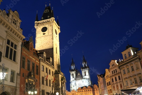 The Church of St. Nicholas and Prague astronomical clock on the background of the night sky in summer