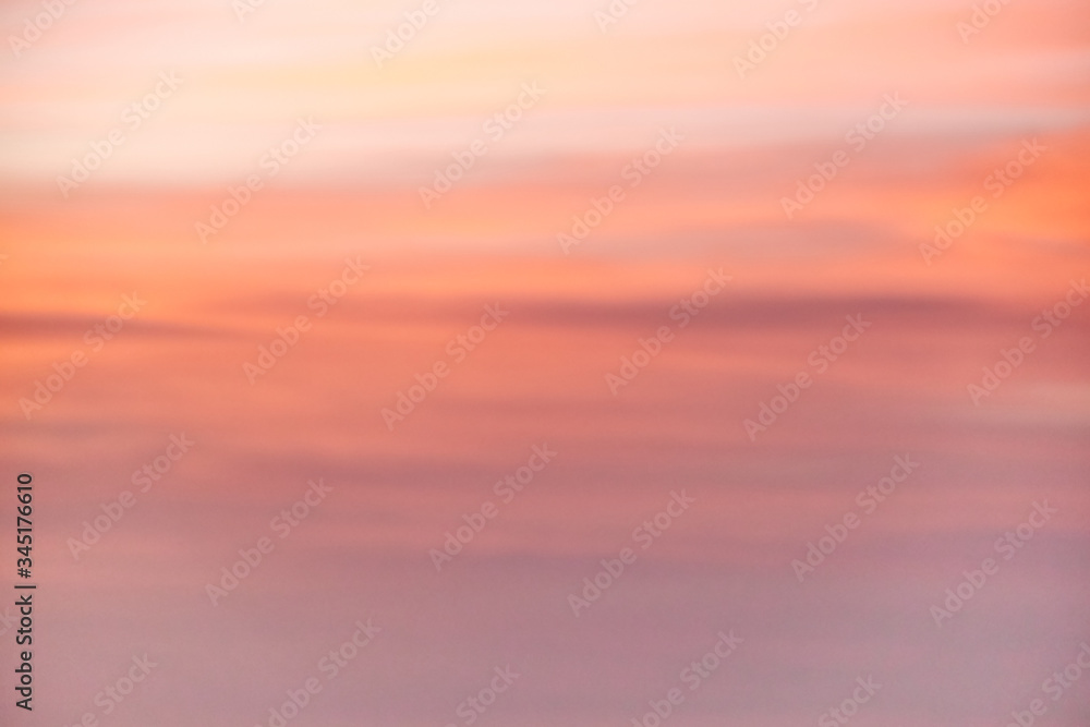 A beautiful blurred light red background of the evening sky