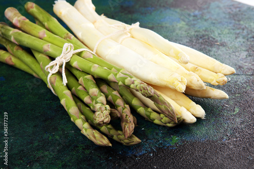White and green asparagus on rustic background.