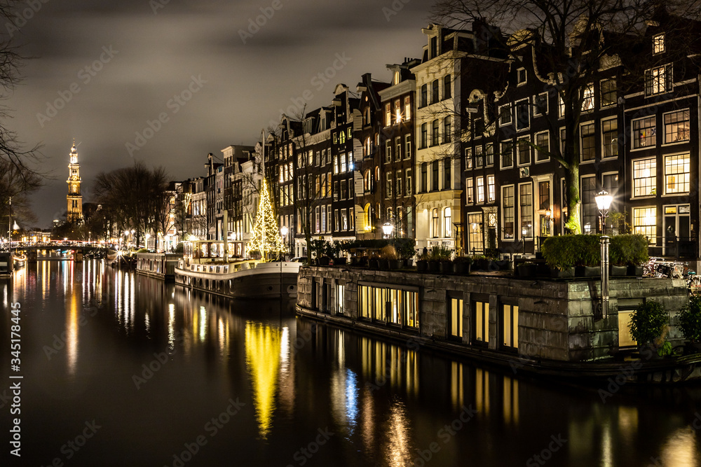 Night lights of channel and biclycles in Amsterdan