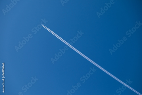 the plane is high in the sky and the trace of the plane