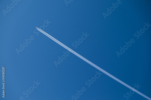 the plane is high in the sky and the trace of the plane