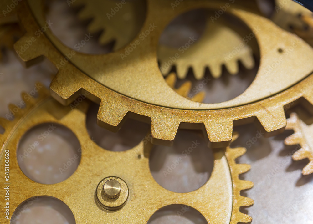 Golden cogs on a marble floor background