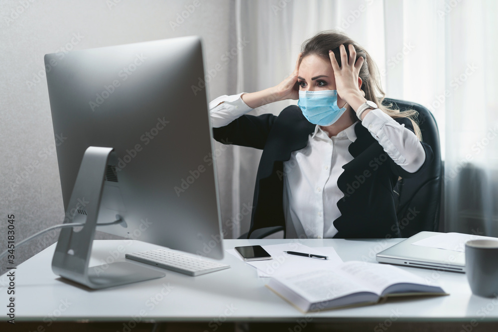 Alarmed young woman works in a home office during quarantine due to the pandemic of the coronavirus Covid-19. Girl in a disposable medical facial mask. Self-isolation to prevent infection Alarmed young woman works in a home office during quarantine due to the pandemic of the coronavirus Covid-19. Girl in a disposable medical facial mask. Self-isolation to prevent infection