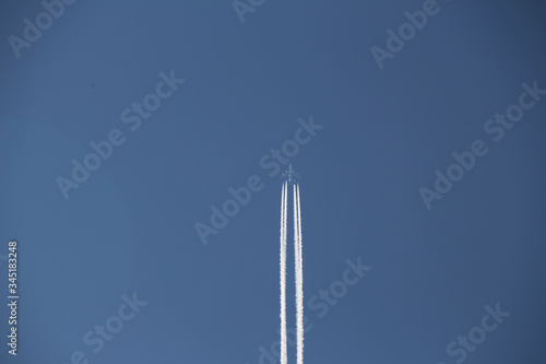 airplane contrail and clear blue sky in background