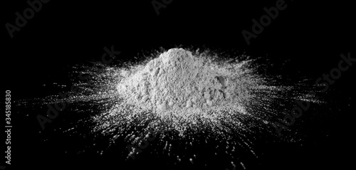 Dry cement  mortar powder  plaster cast pile isolated on black background