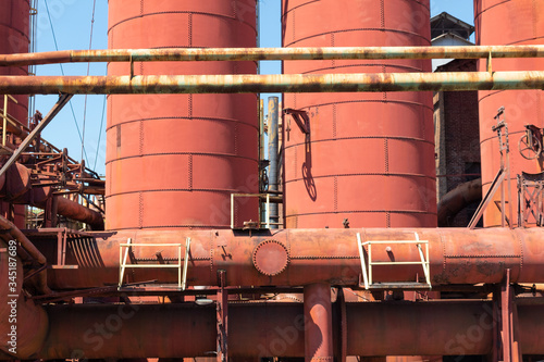 Sloss Furnaces National Historic Landmark, Birmingham Alabama USA, rusted metal plates riveted into round structures, heavy industrial scene, horizontal aspect photo