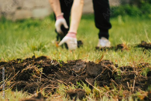 Wallpaper Mural Close up man digs soil with metal shovel. Digging ground for plant seeding. Agriculture concept. Worker in gloves  Torontodigital.ca