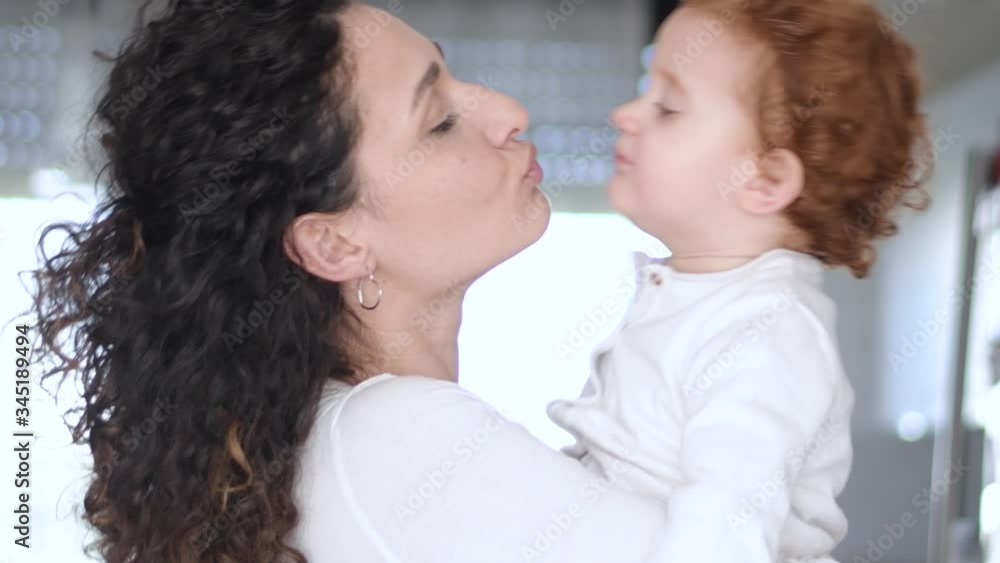 Slow motion 4K, two year old girl Beautiful Mother And her baby girl outdoors. Nature. Beauty Mom and her baby girl play together Kissing and hugging happy family. Mother's Day Joy. Slow motion 4K, two year old girl Beautiful Mother And her baby girl outdoors. Nature. Beauty Mom and her baby girl play together Kissing and hugging happy family. Mother's Day Joy.