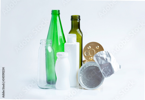 Glass garbage, plastic, aluminium on a gray background.