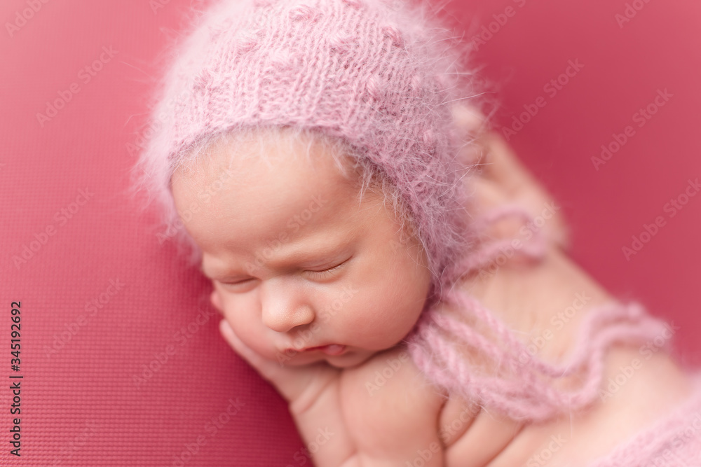 first photo shoot. newborn child. newborn. the baby is lying on a pink blanket. newborn girl first photo shoot. newborn child. newborn. the baby is lying on a pink blanket. newborn girl
