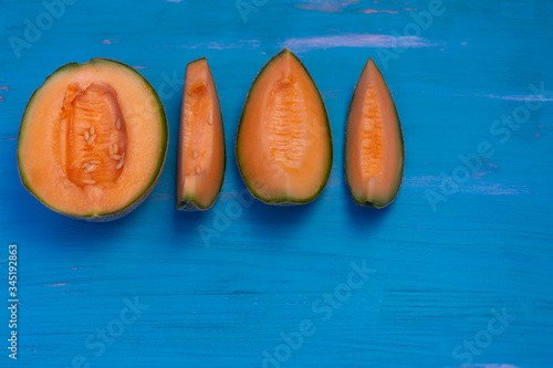 Melon on blue table, with plate blue and white.